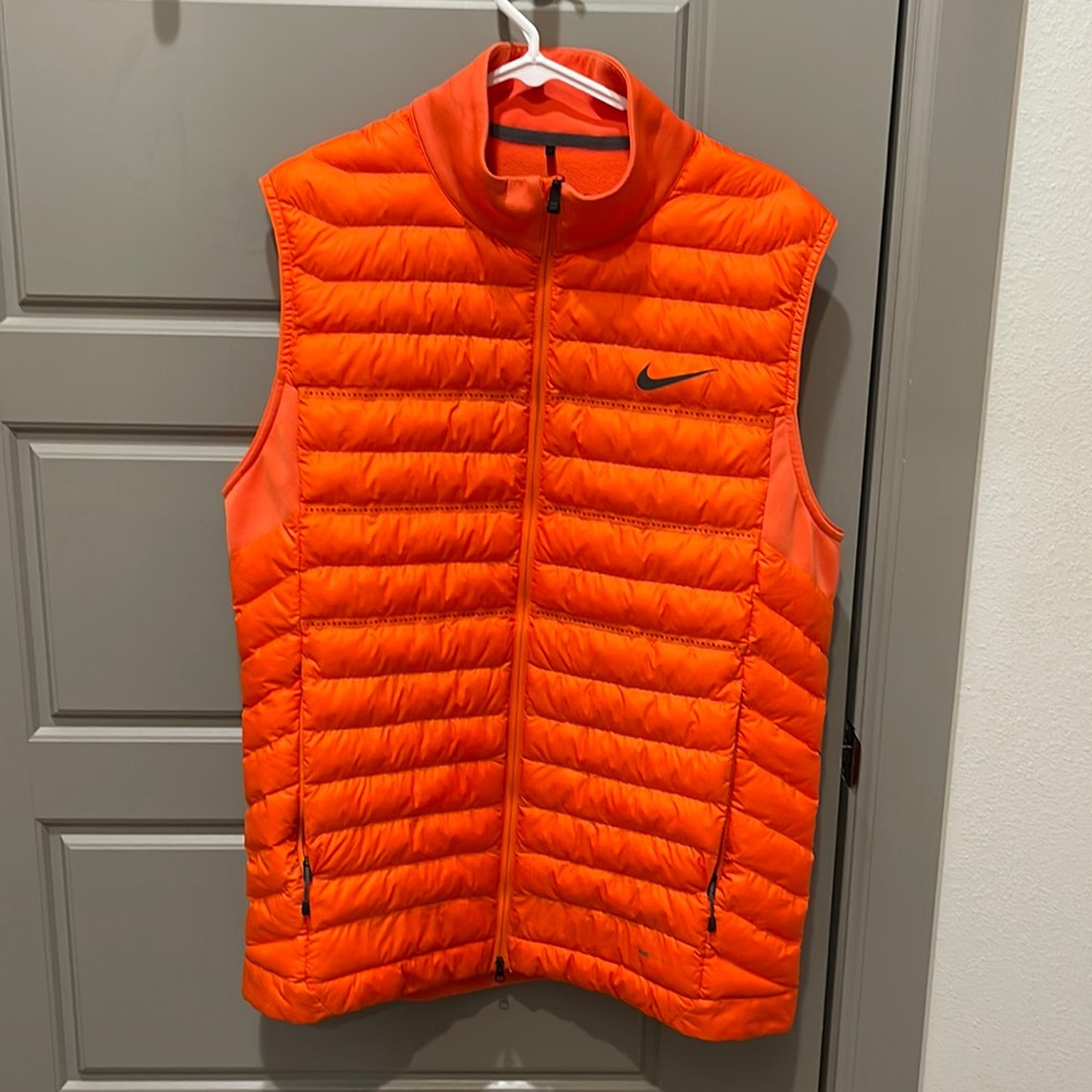 Orange Nike Golf Vest. Size Large. Inside and pockets fleece lined Hardly worn.